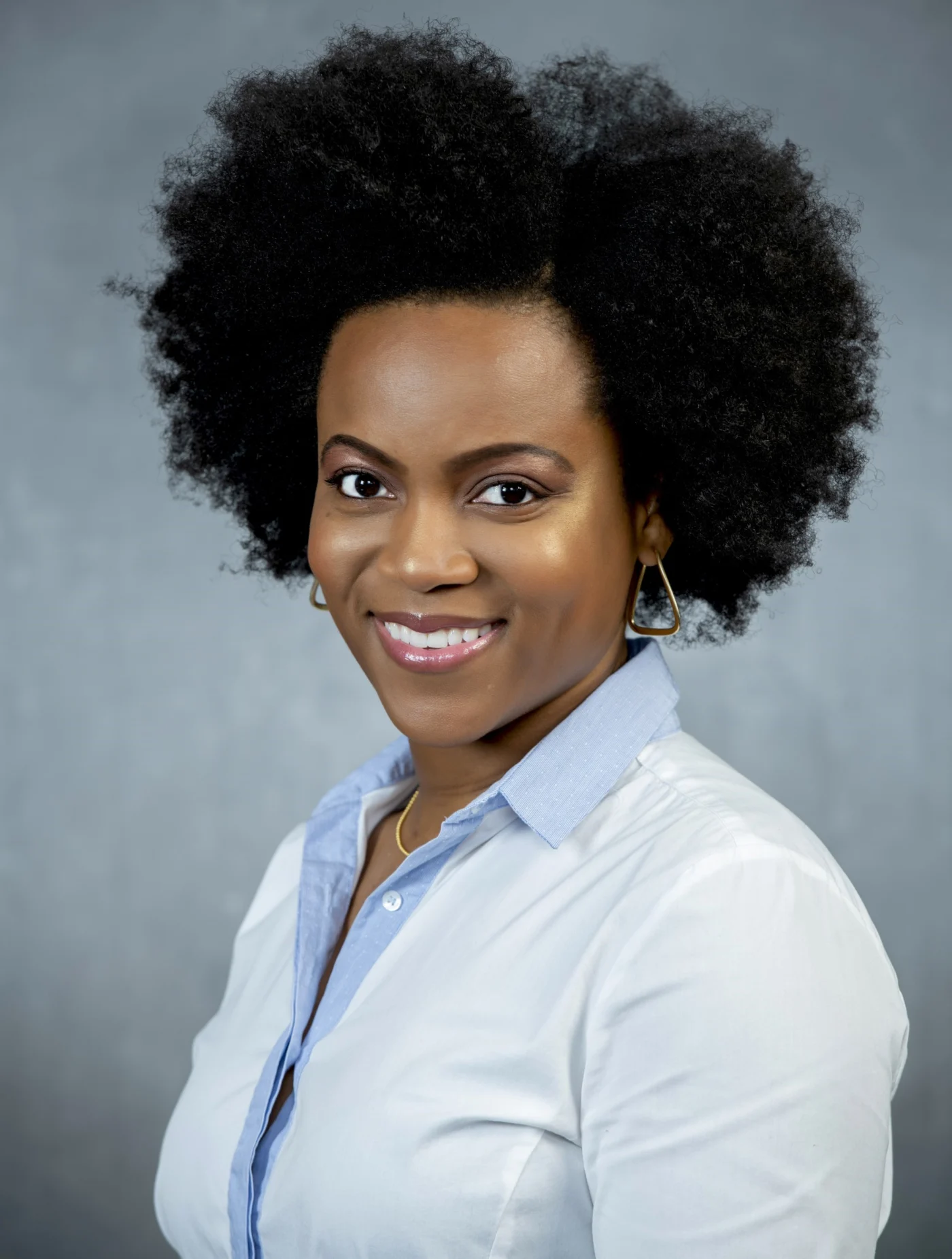 Professional studio headshot of a woman in a white shirt