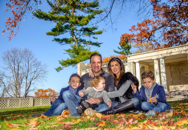 Family posing outdoors among autumn foliage