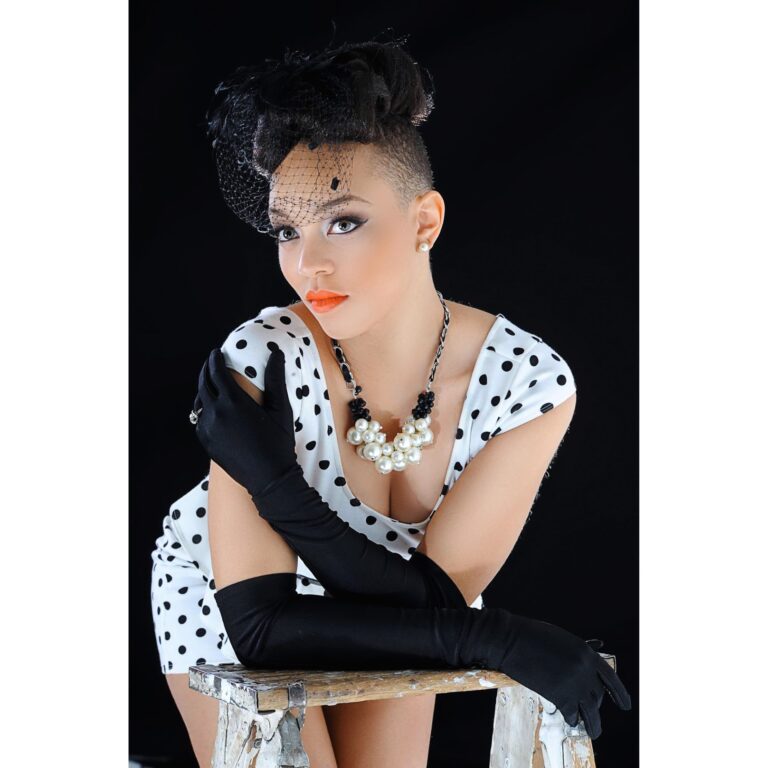 Woman in a polka-dot outfit in a stylized studio portrait