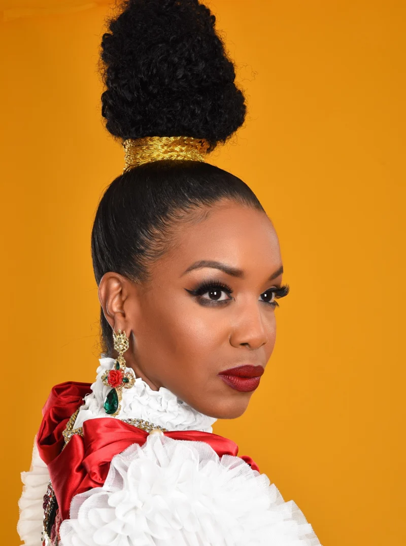 Studio fashion portrait against a warm yellow background
