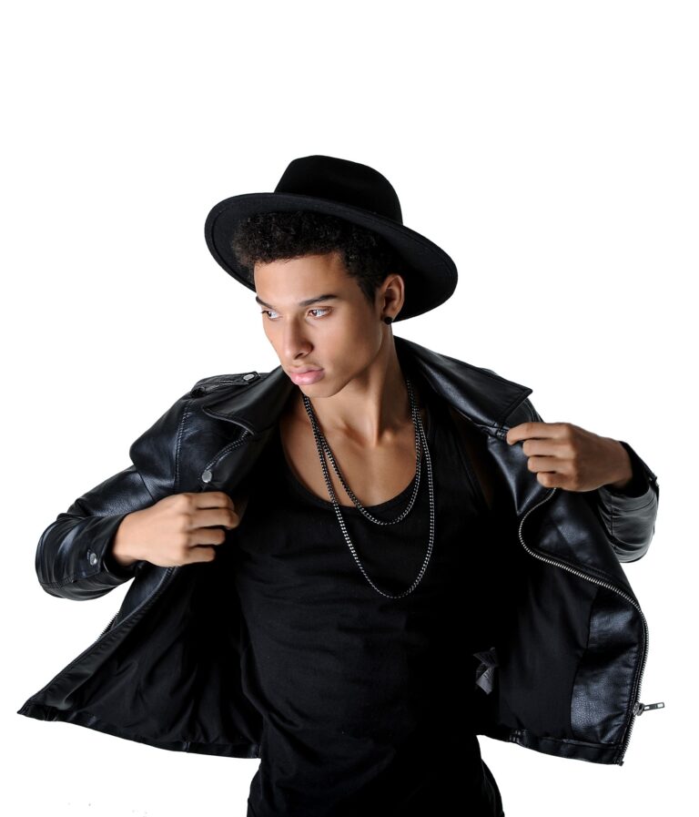 Man in a black hat and coat in a stylized studio portrait