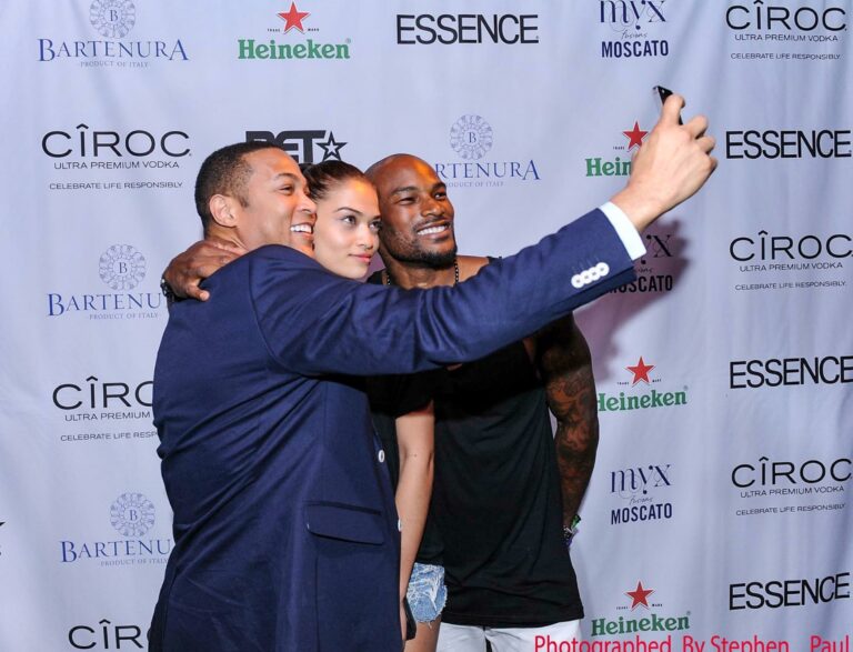 Group taking a selfie at a branded event backdrop