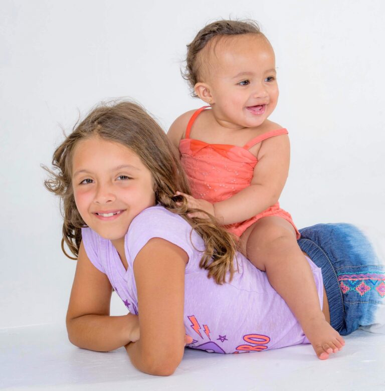Two girls posing in a studio