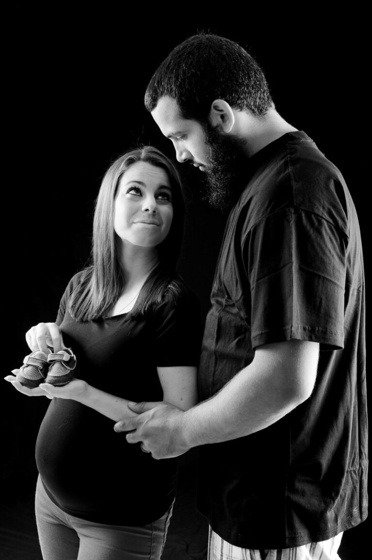 Expectant couple posed in black and white
