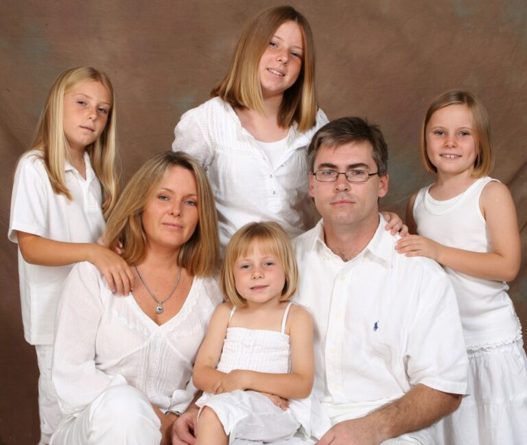 Family group posing in white clothing