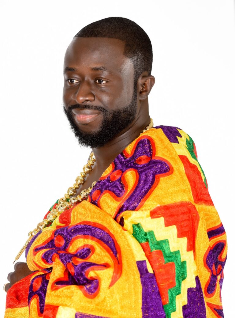 Man in colorful patterned attire against white