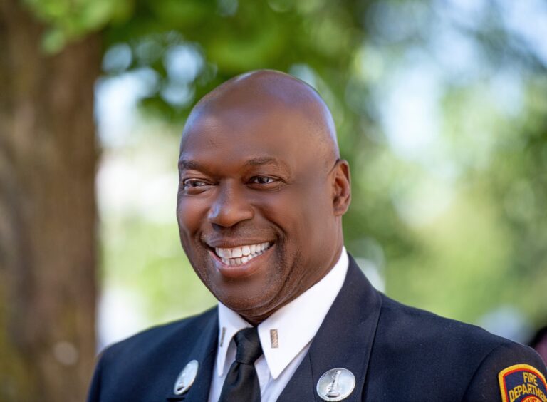 Smiling uniformed man outdoors