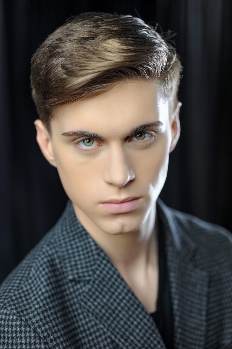 Man in patterned jacket, dark background