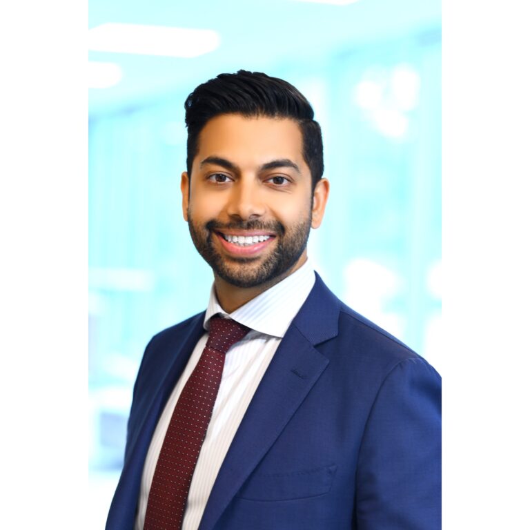 Smiling man in blue suit, bright background