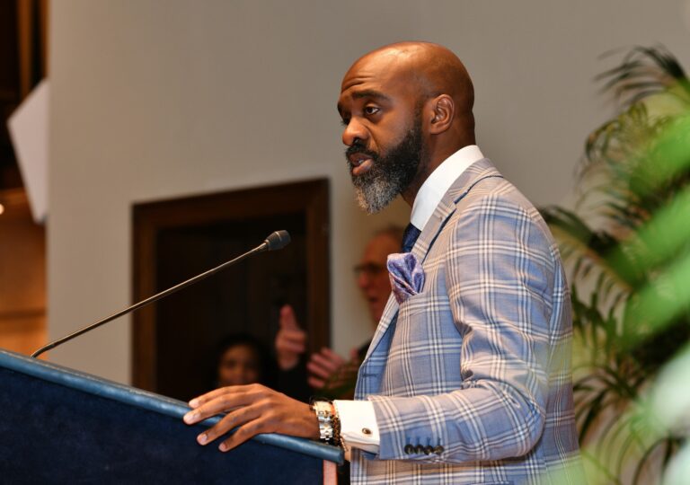 Man speaking at a lectern