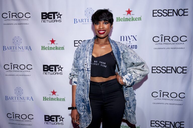 Woman posing at a branded reception backdrop