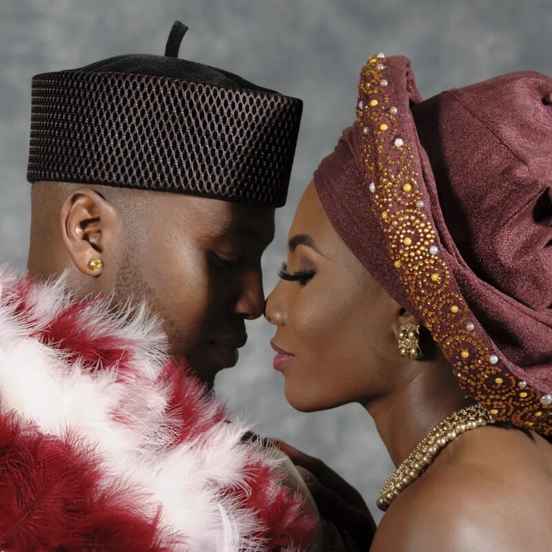 Close portrait of a couple in richly detailed celebration attire