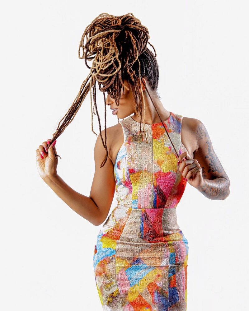 Studio fashion portrait in a colorful fitted dress with an elaborate updo