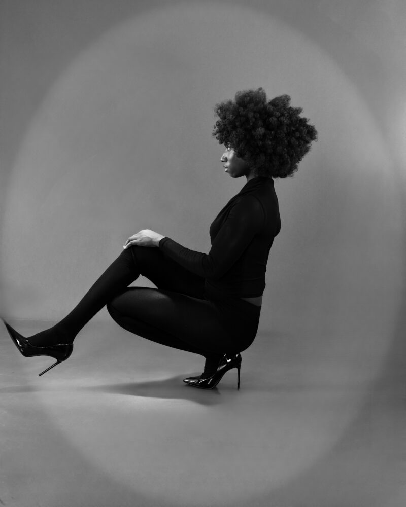 Monochrome profile portrait in a seated pose