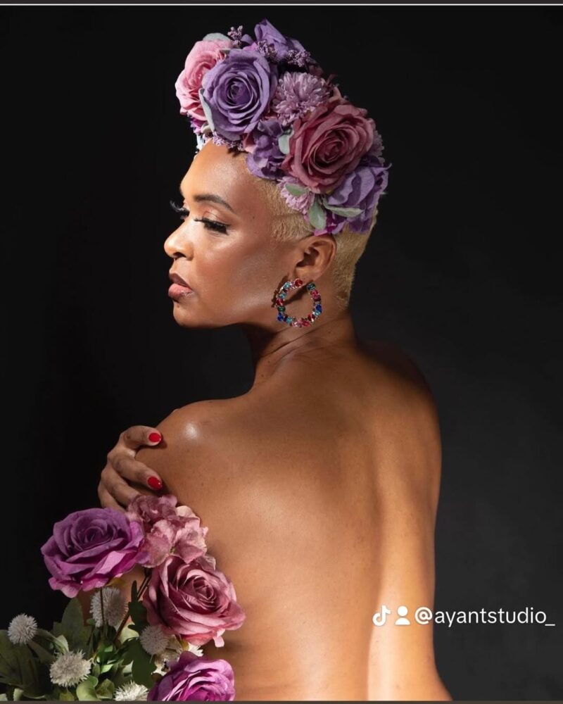 Beauty portrait with a purple floral headpiece and matching flowers