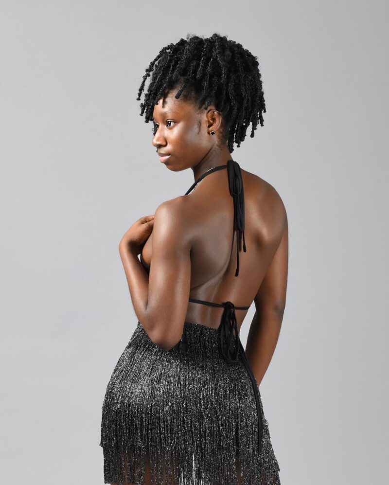 Studio fashion portrait of a woman in a shimmering black dress