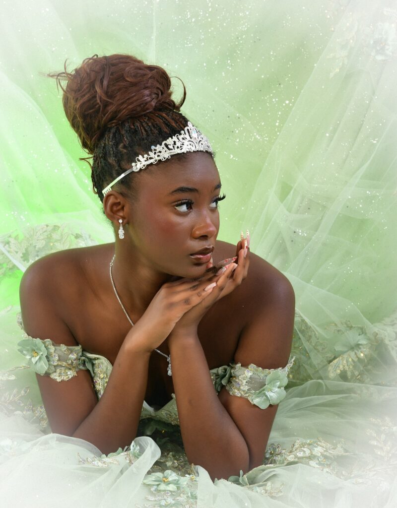 Close-up studio portrait with a tiara and pale green gown