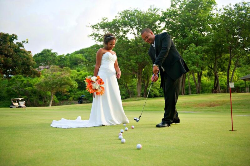 Bride and groom sharing a playful moment on a golf course
